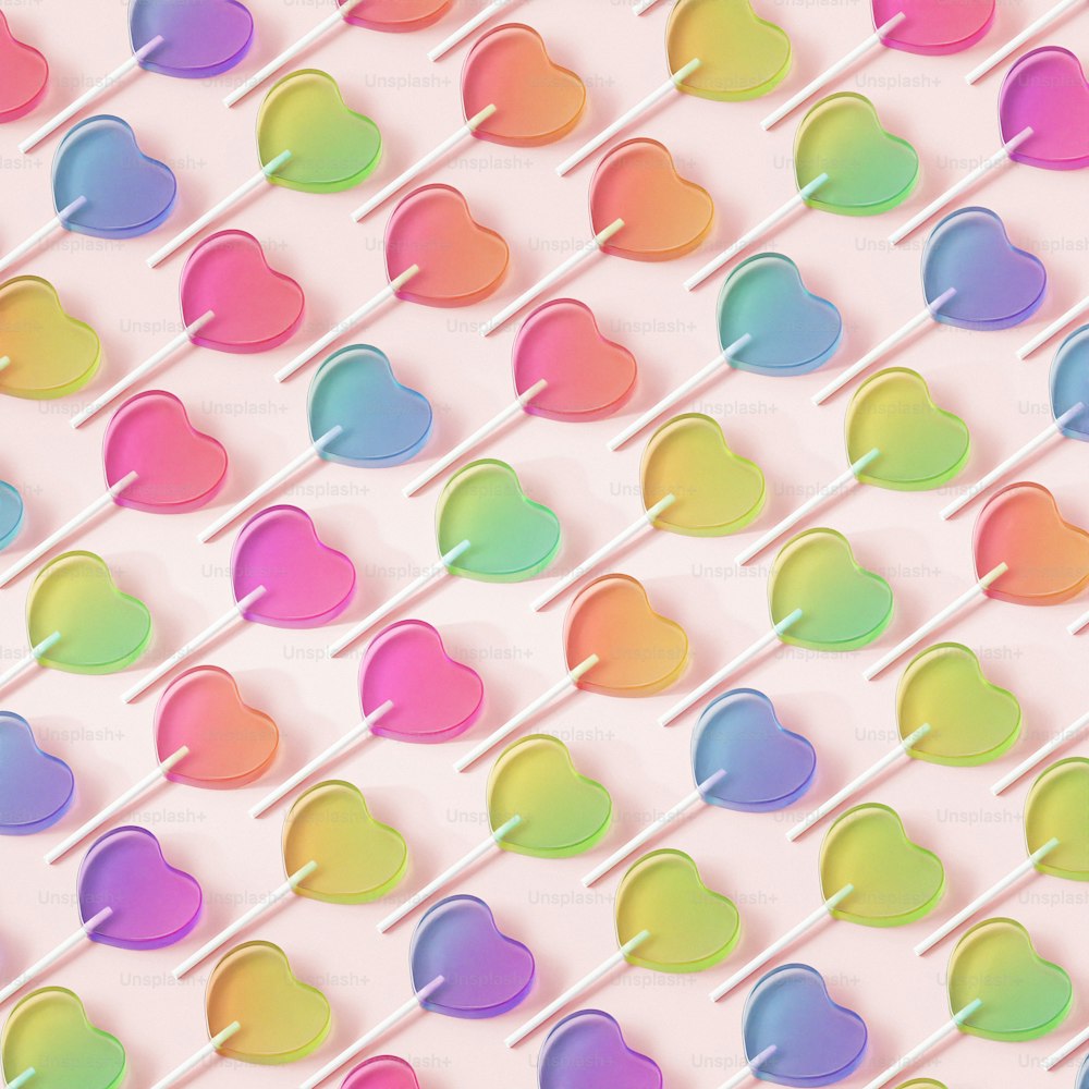 a background of lollipop hearts on a pink background