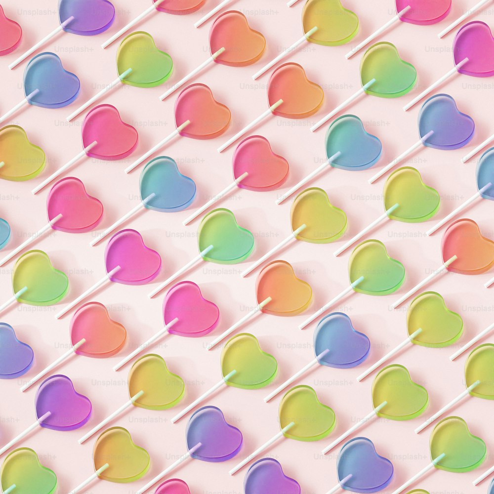 a background of lollipop hearts on a pink background
