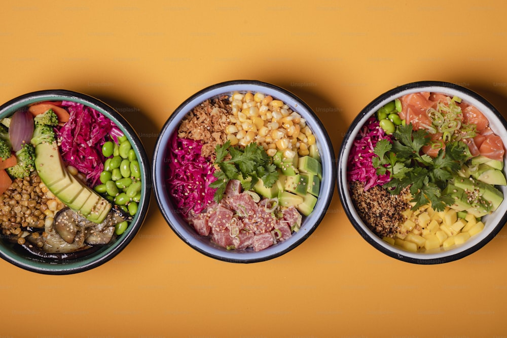 three bowls filled with different types of food