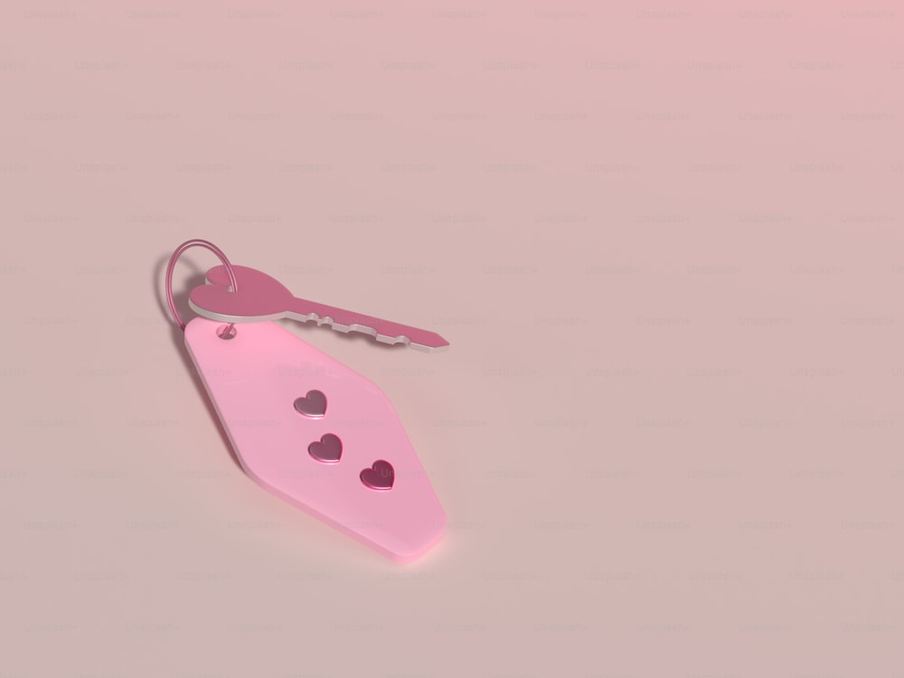 a pink keychain with a heart cut out of it