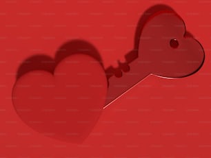 una chiave rossa a forma di cuore su sfondo rosso