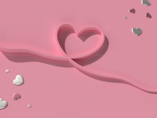 un objeto en forma de corazón sobre una superficie rosada