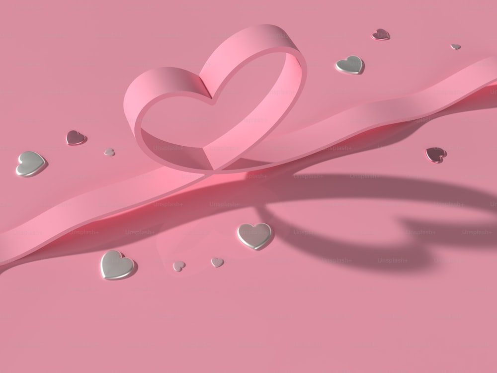 a pink ribbon with a heart cut out of it
