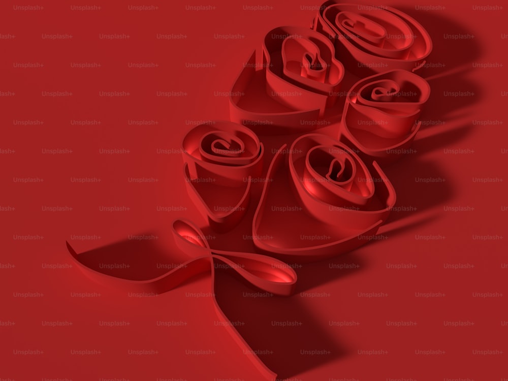 赤い背景にリボンが付いた赤いバラの束