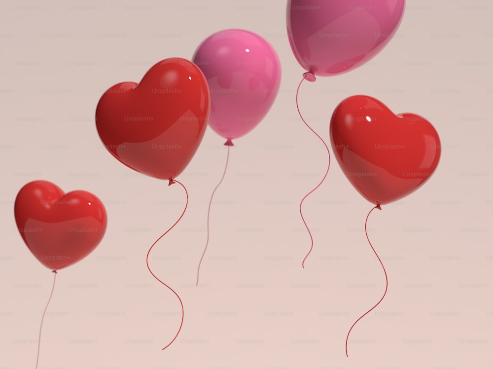 Un grupo de globos en forma de corazón flotando en el aire