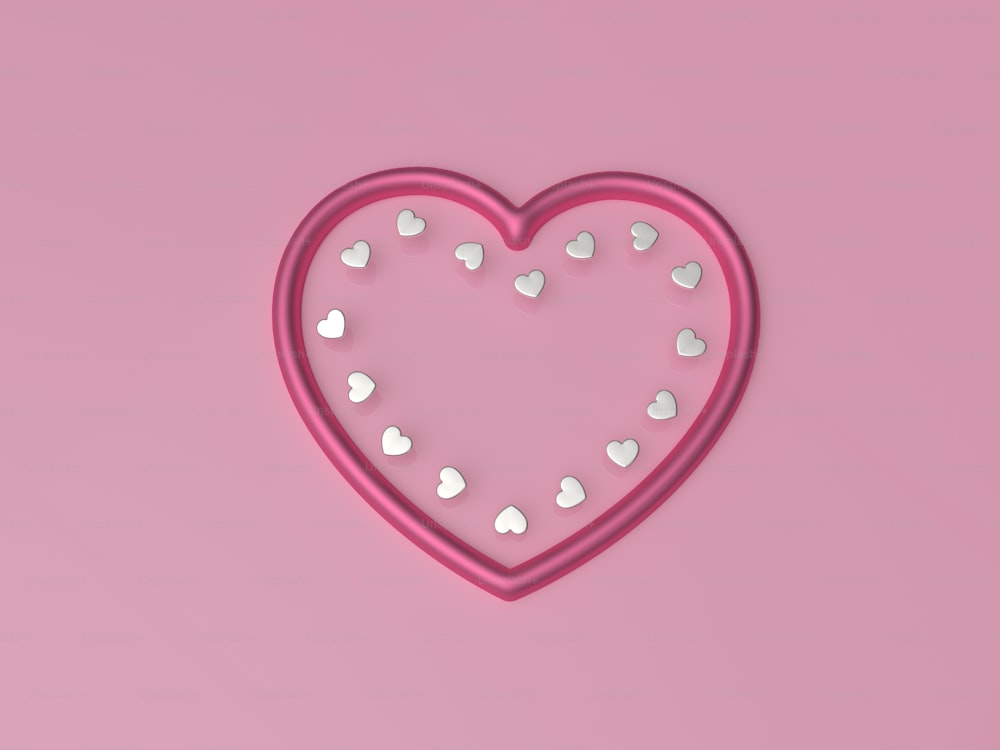 um cortador de biscoito em forma de coração em um fundo cor-de-rosa