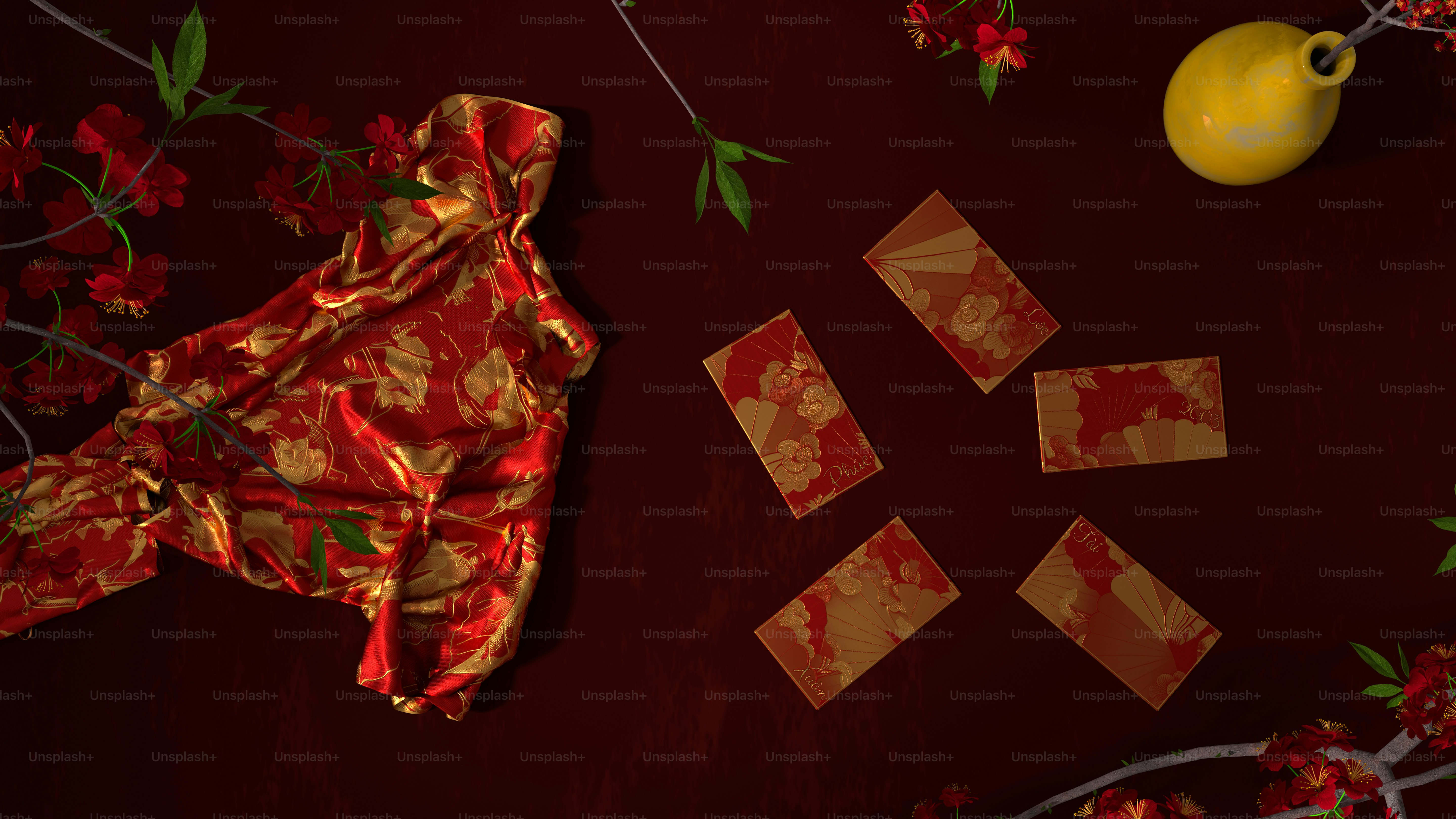 a red table topped with red flowers and a yellow vase