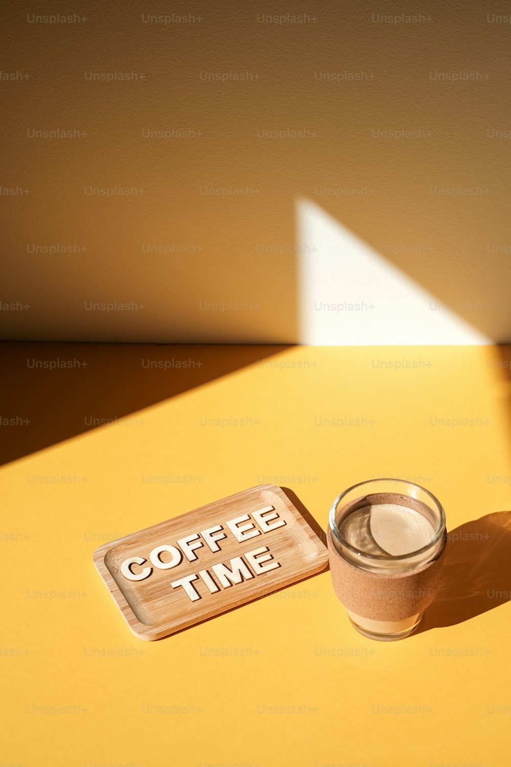 a cup of coffee next to a sign that says coffee time