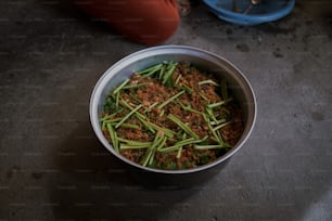 a bowl filled with green beans and meat