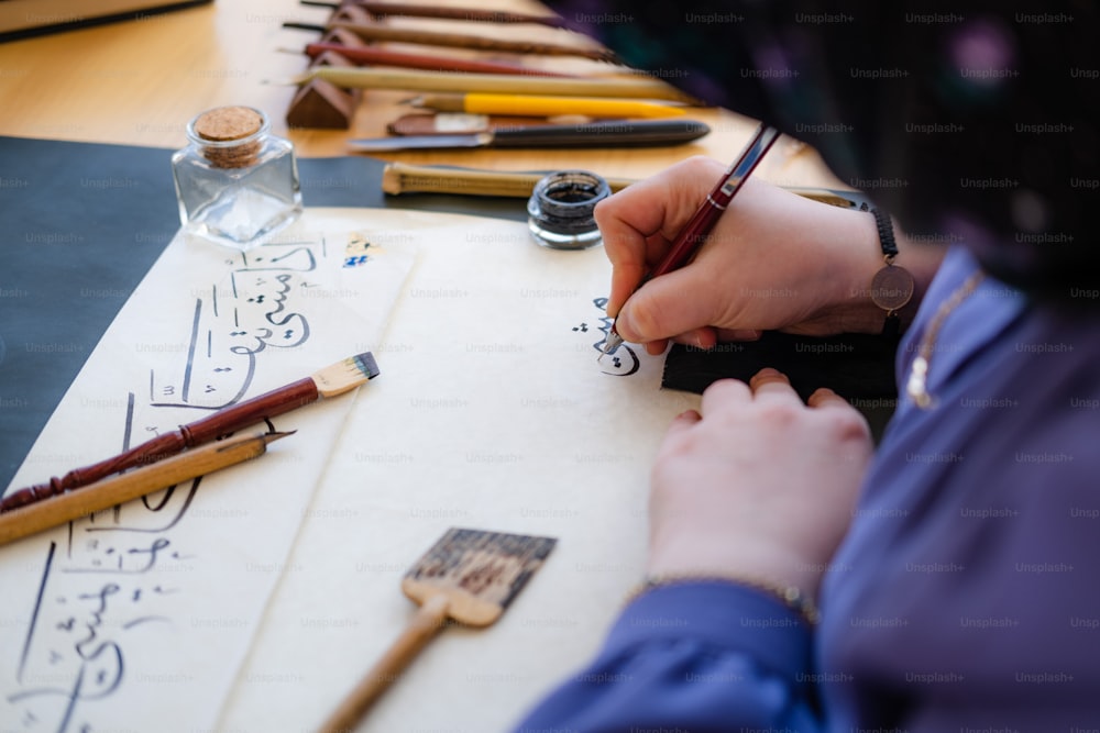 a person writing on a piece of paper