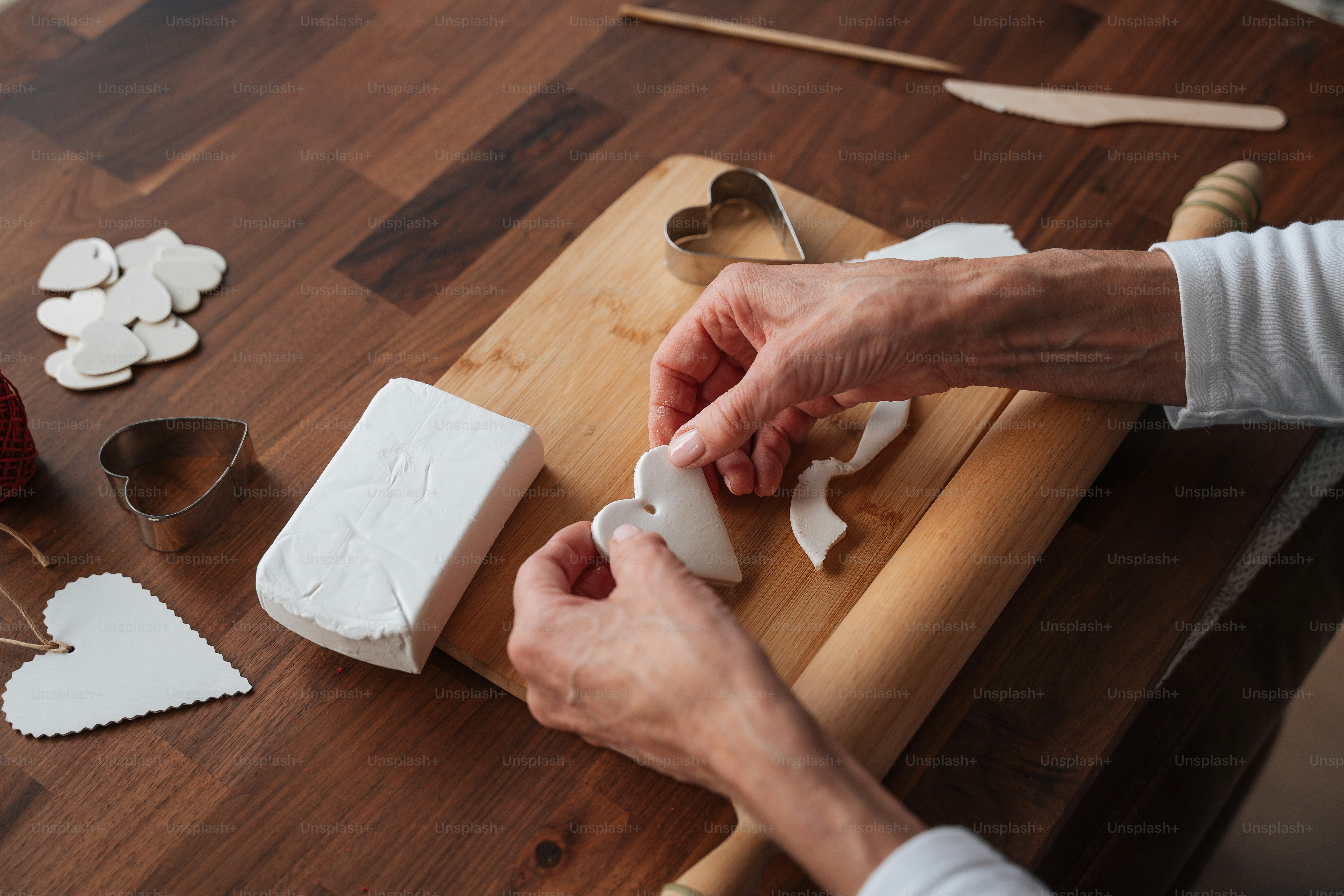a person is decorating a cake with white icing