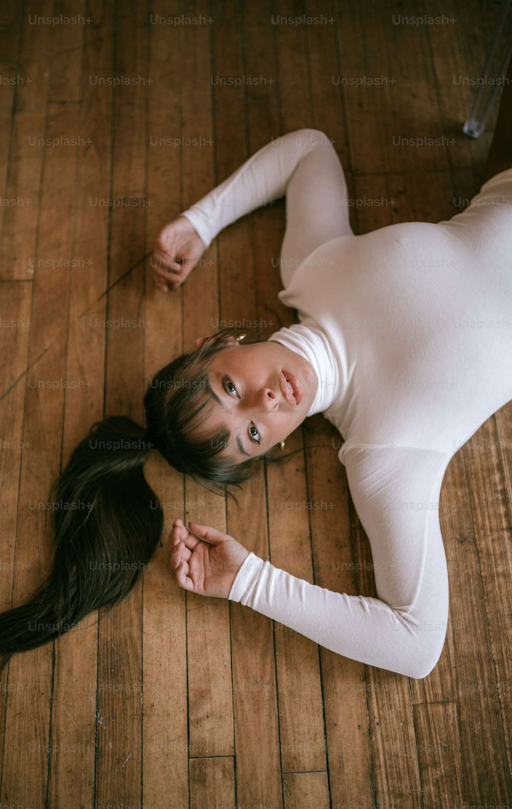 a woman laying on the floor with long hair