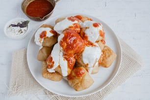 a white plate topped with pizza covered in sauce