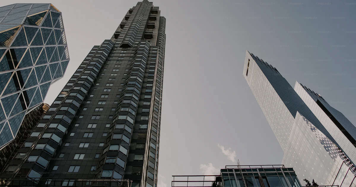 Two High Rise Building Together A couple of tall buildings next to each other photo – Apartments Image ...