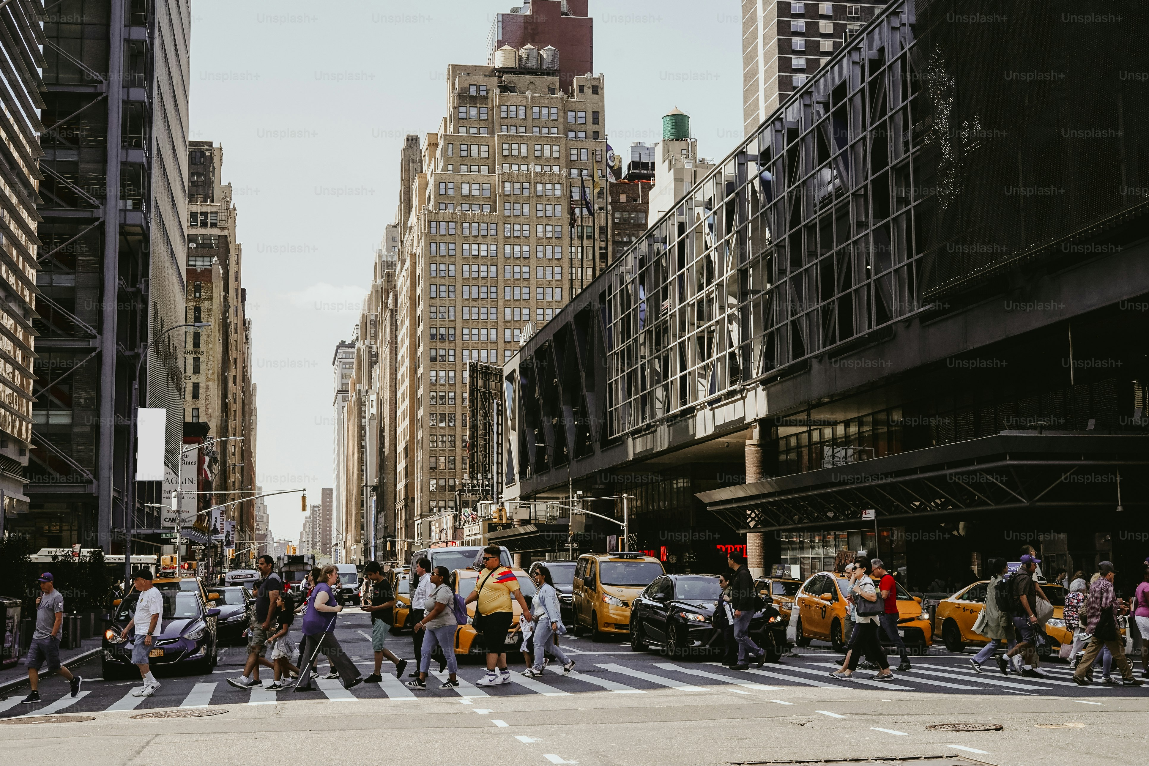 a group of people crossing a street in a city