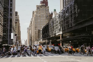 a group of people crossing a street in a city