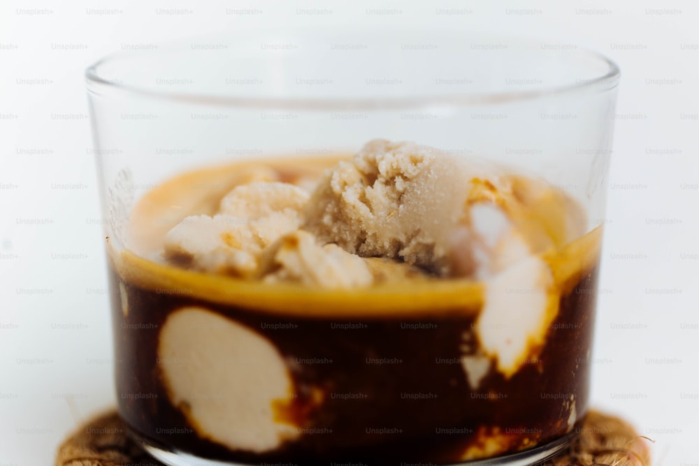a dessert in a glass with ice cream on top