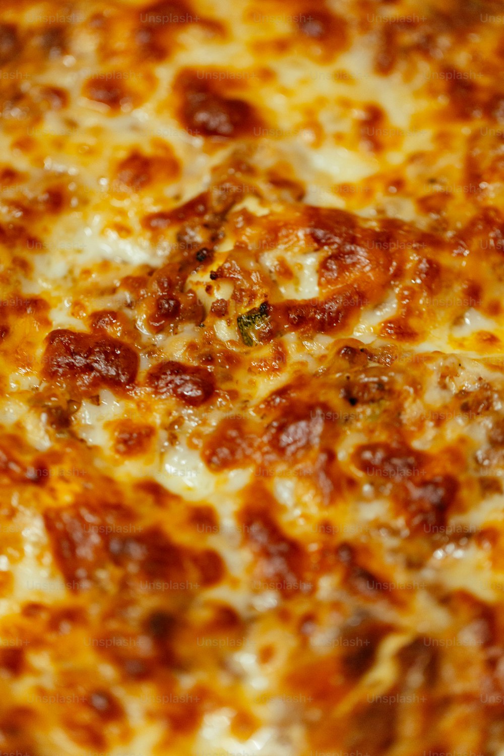 a close up of a pizza with cheese and pepperoni