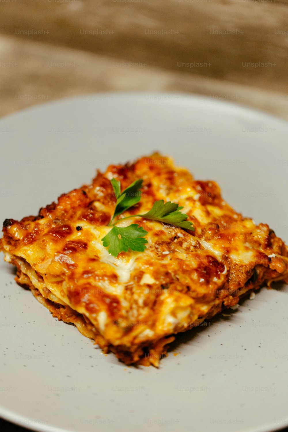 a square piece of lasagna on a white plate