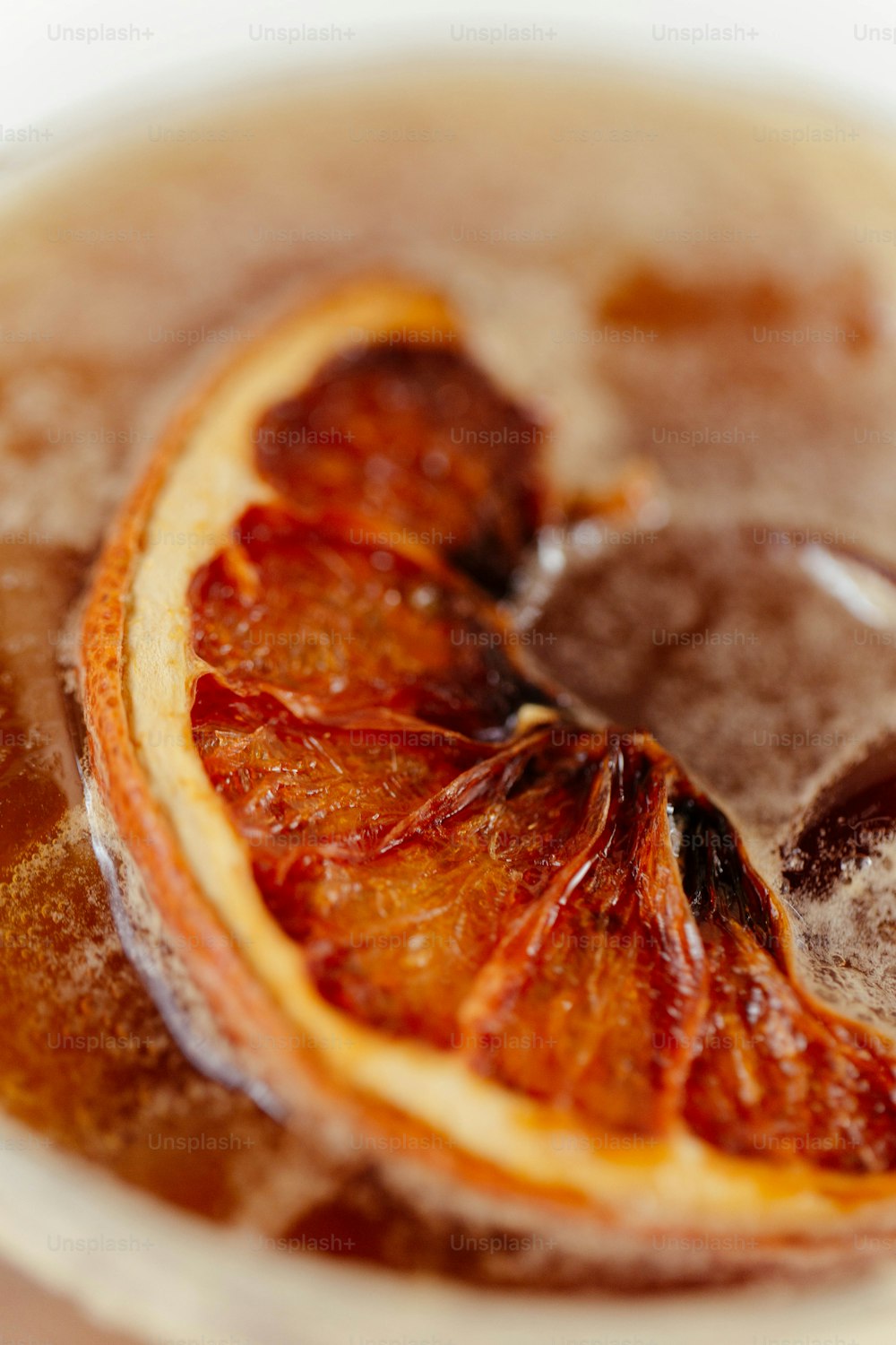 a close up of an orange slice in a cup