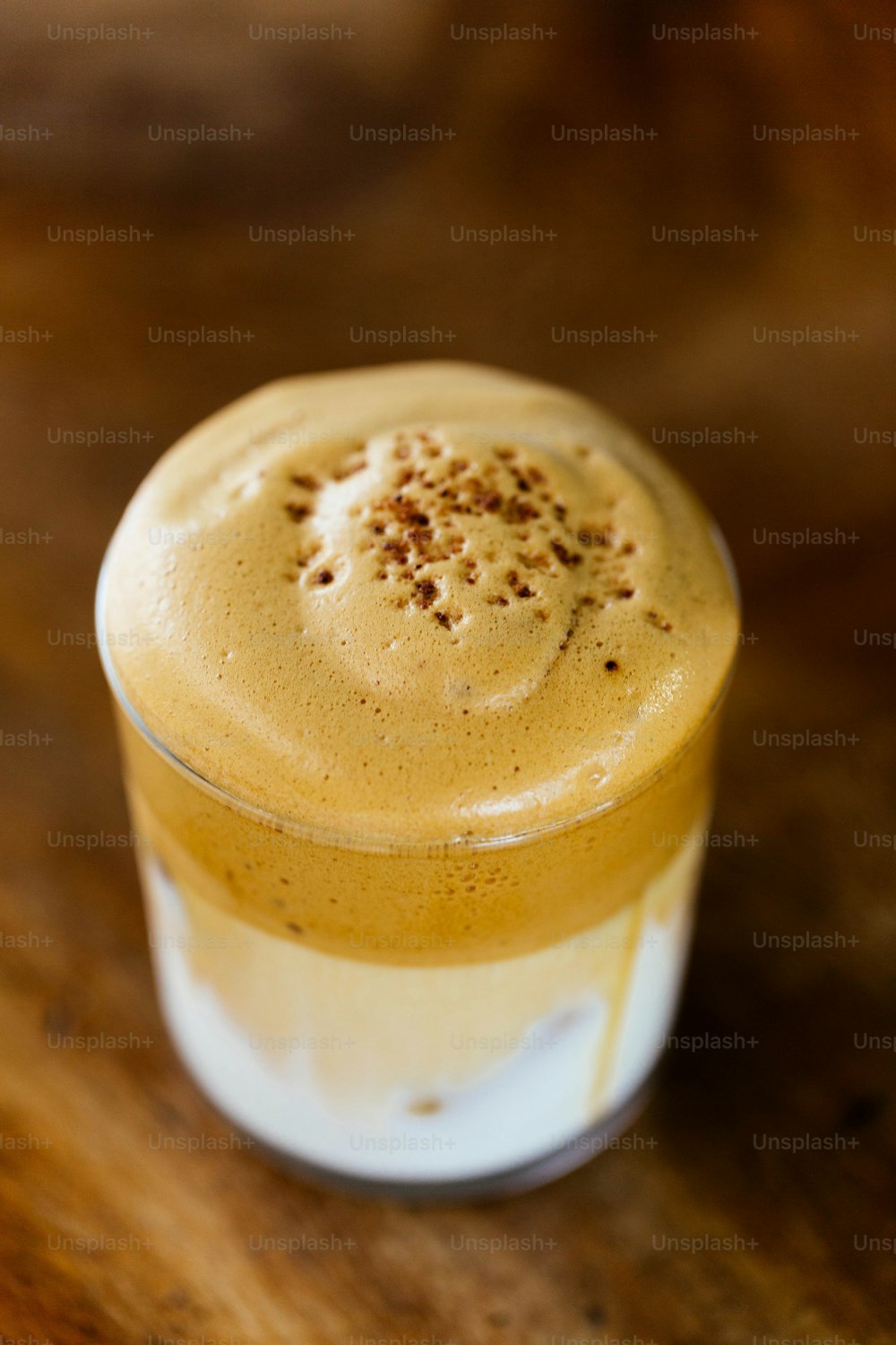 a cup of coffee sitting on top of a wooden table