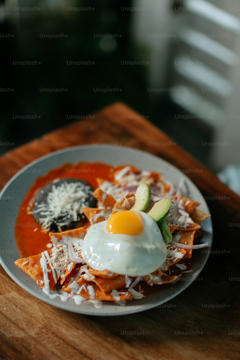 a plate of food with an egg on top of it