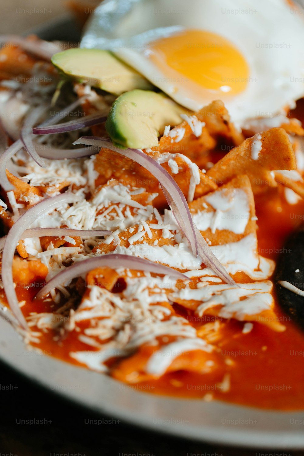 a plate of food with eggs, meat, and vegetables