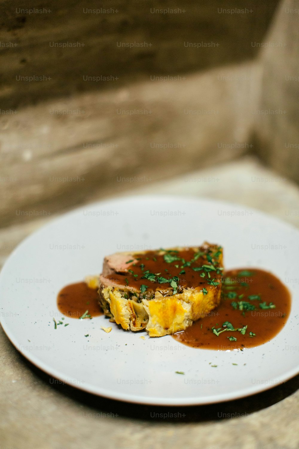 a white plate topped with an omelet covered in gravy