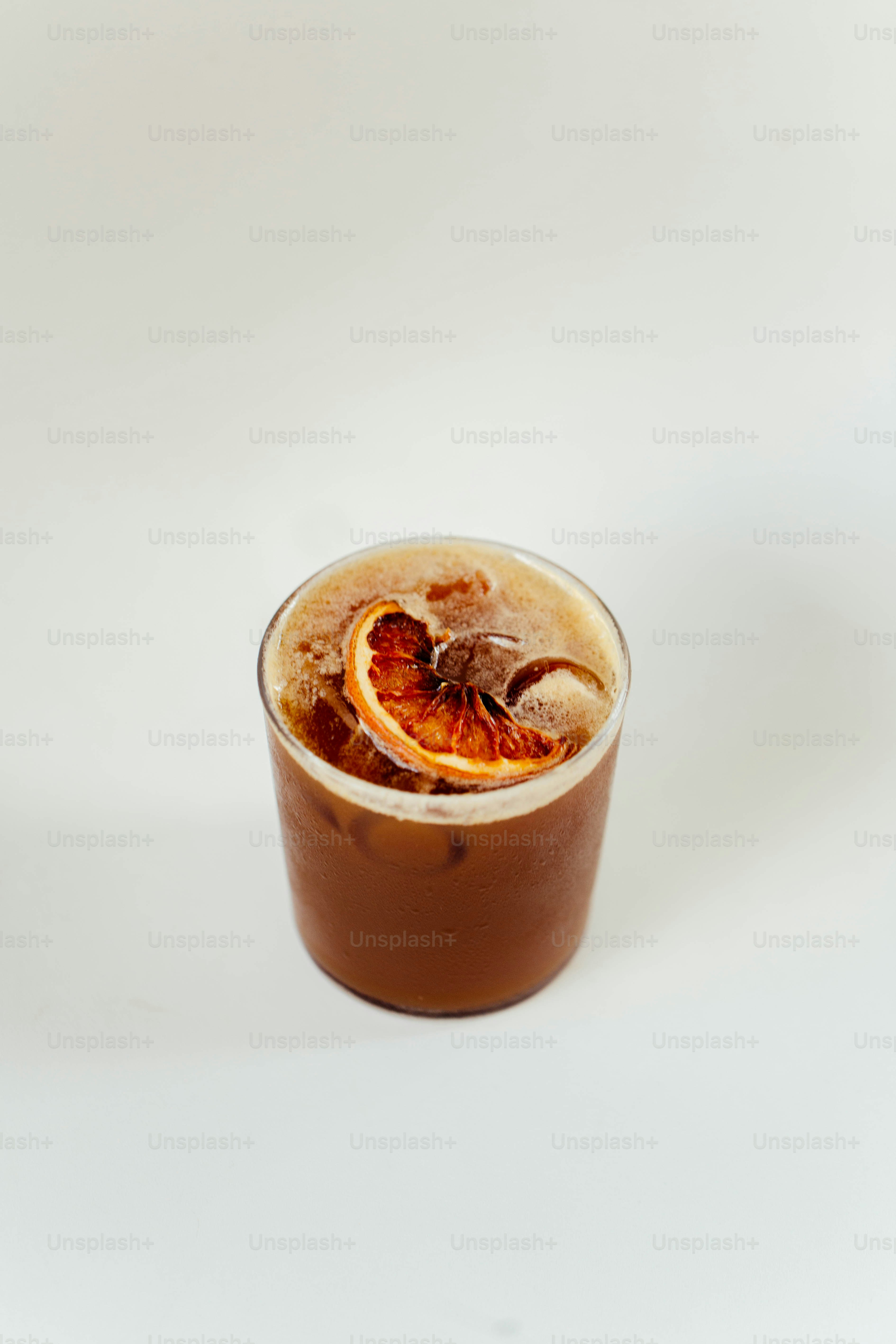 a drink with a slice of orange on top of it