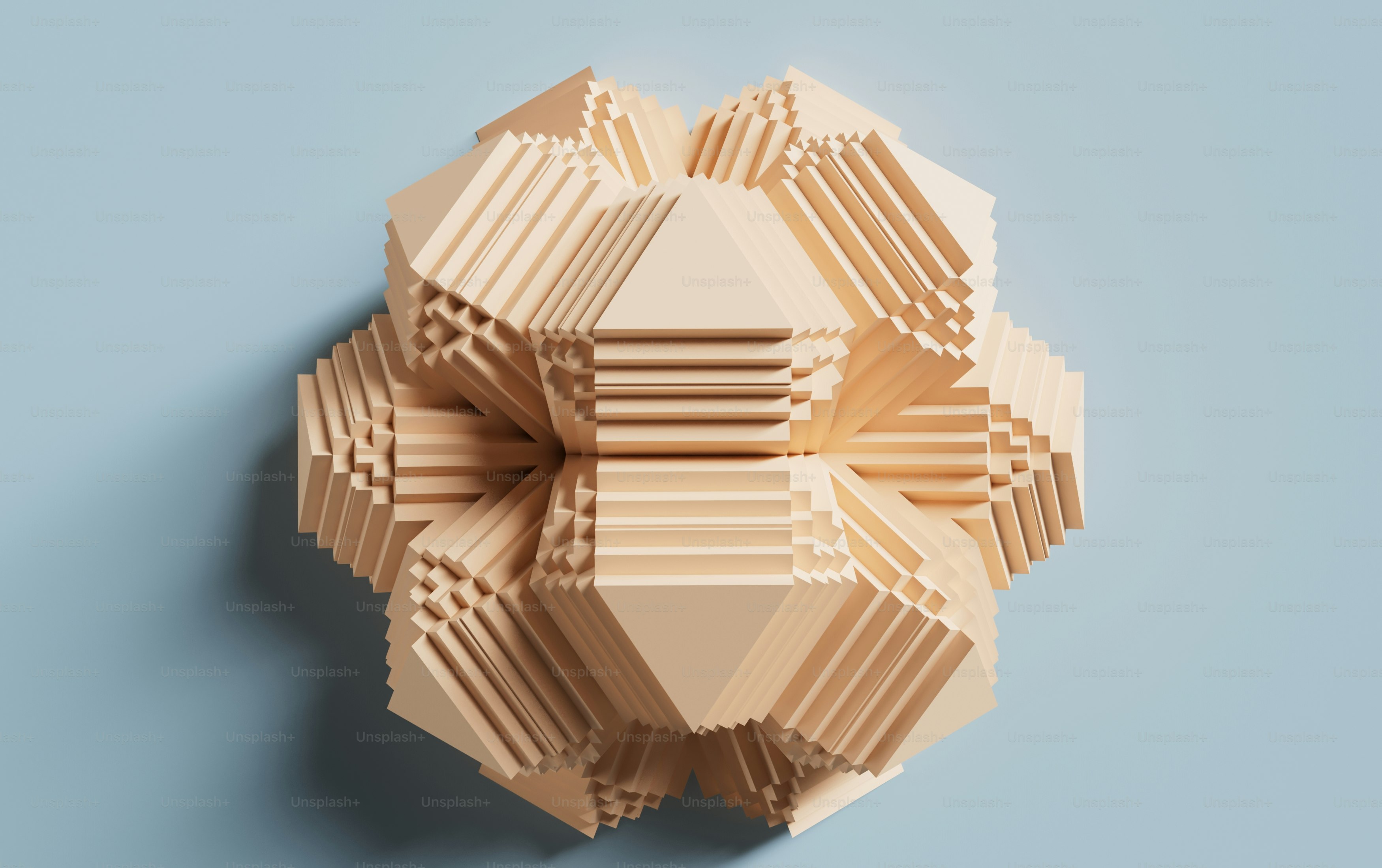 a sculpture made out of wooden blocks on a blue surface