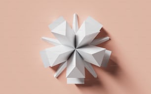 a white origami object on a pink background