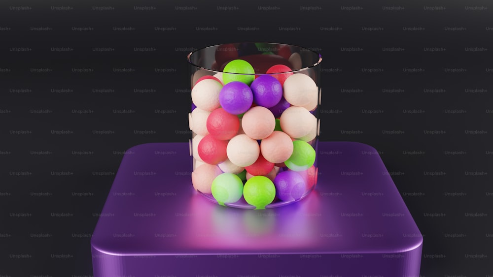 a glass filled with lots of different colored balls