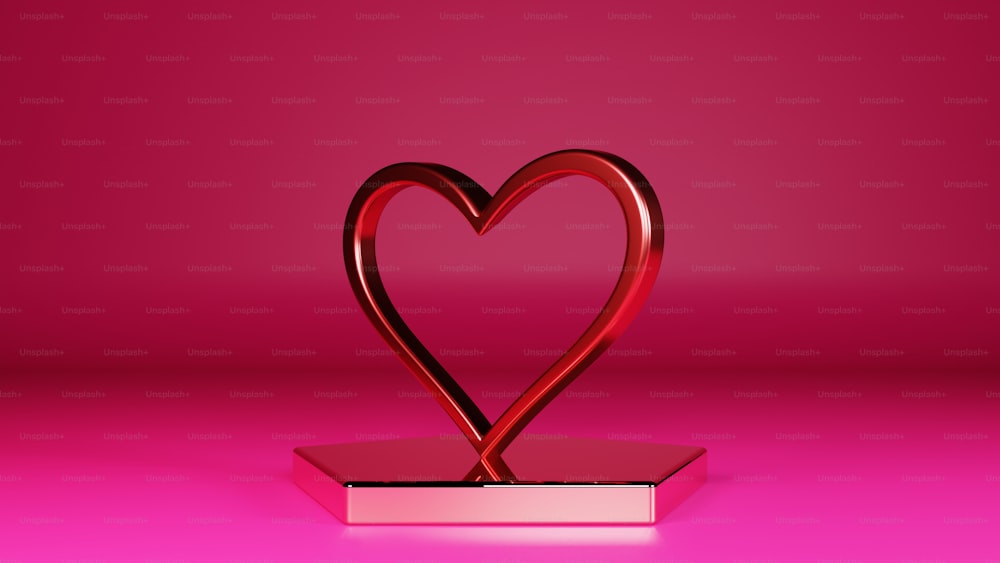 Un objeto rojo en forma de corazón sobre un fondo rosa