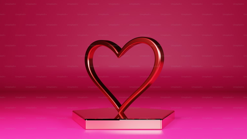 a red heart shaped object on a pink background