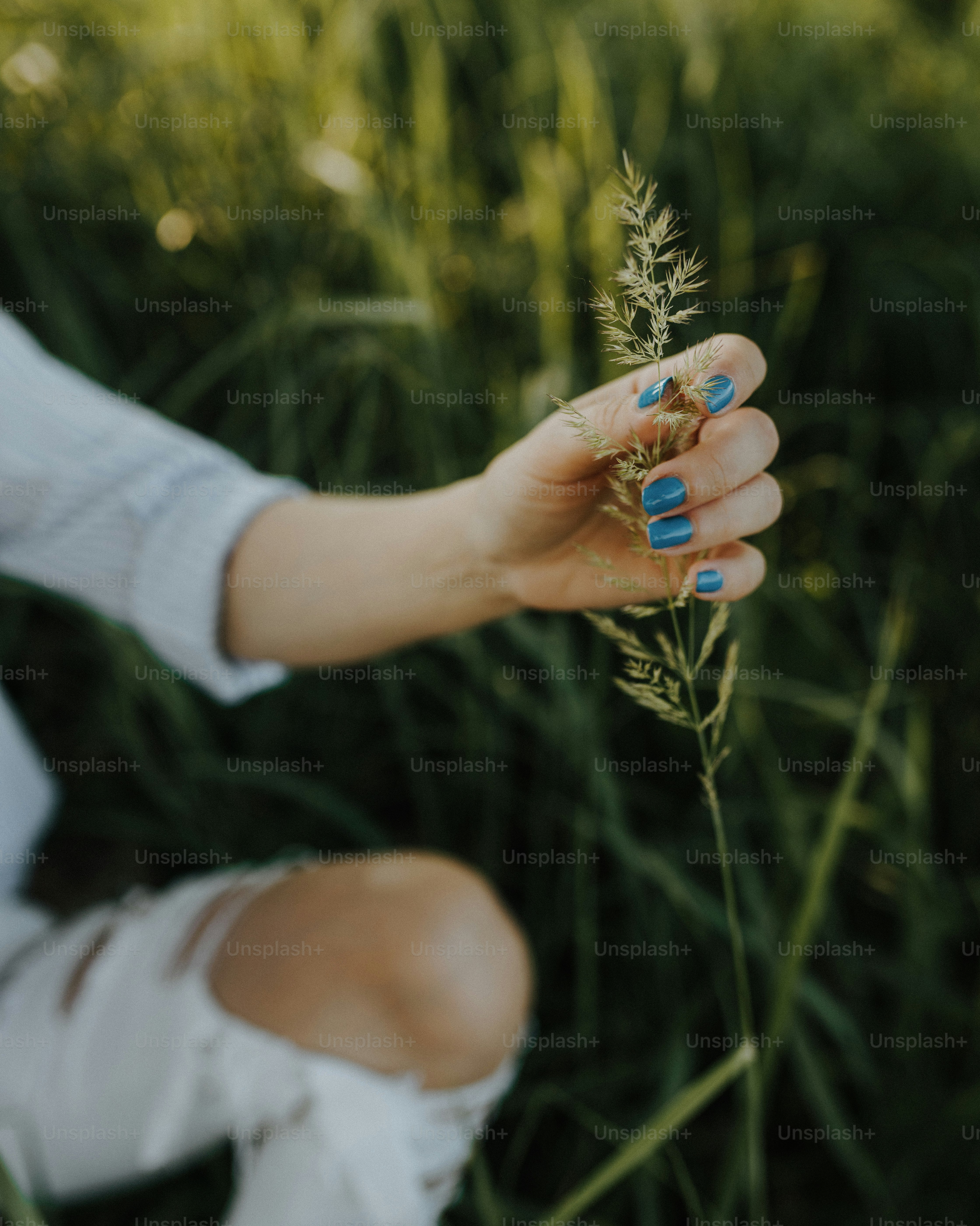a woman holding a flower in her hand