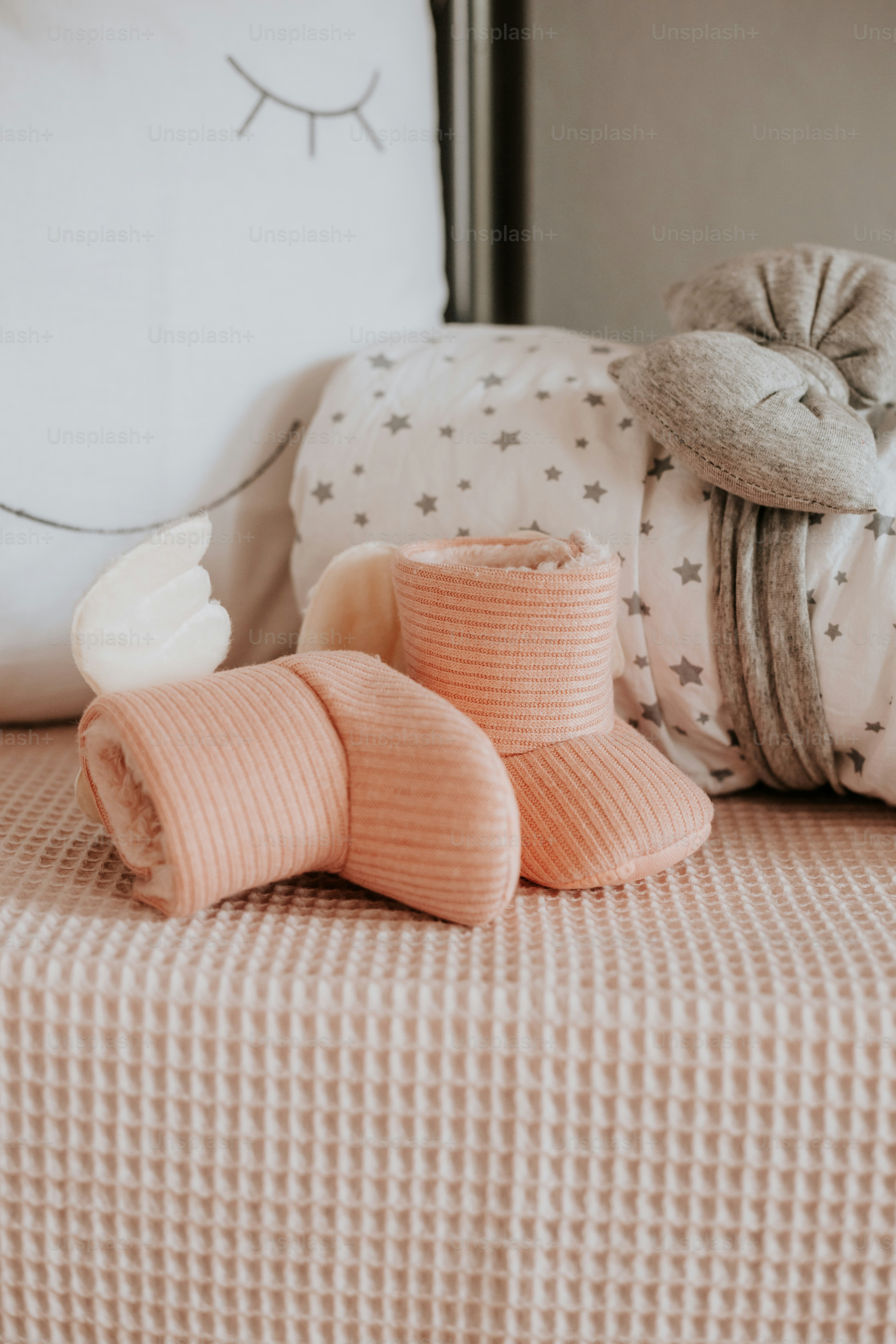 a bed topped with pillows and blankets next to a pillow