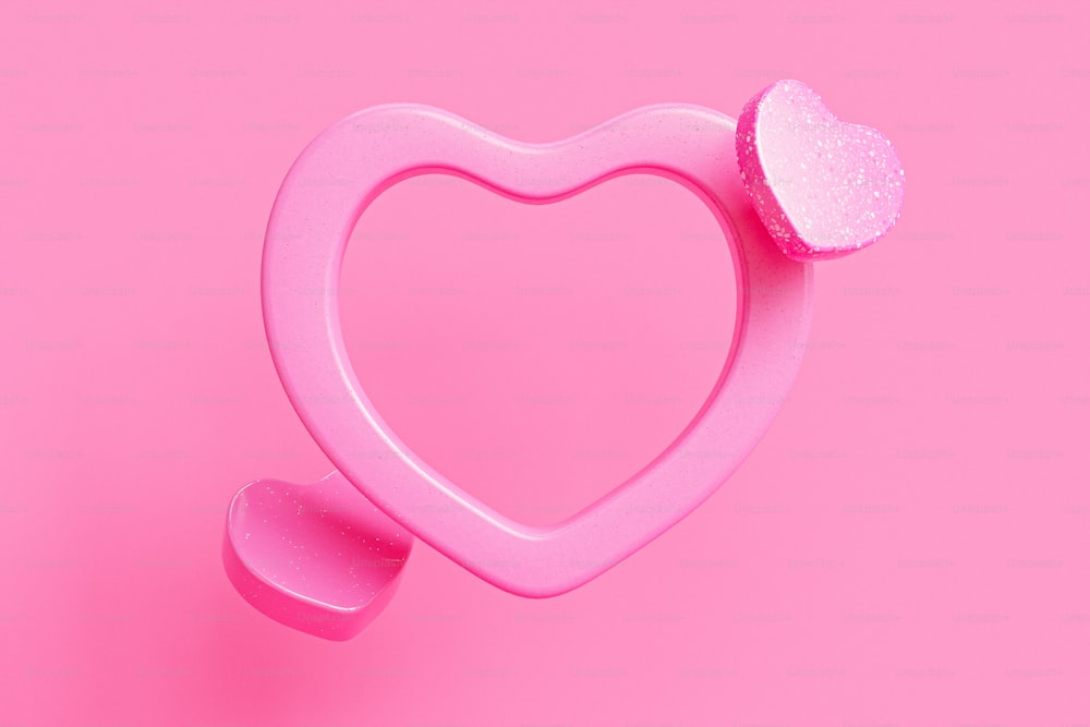 un oggetto rosa a forma di cuore su uno sfondo rosa
