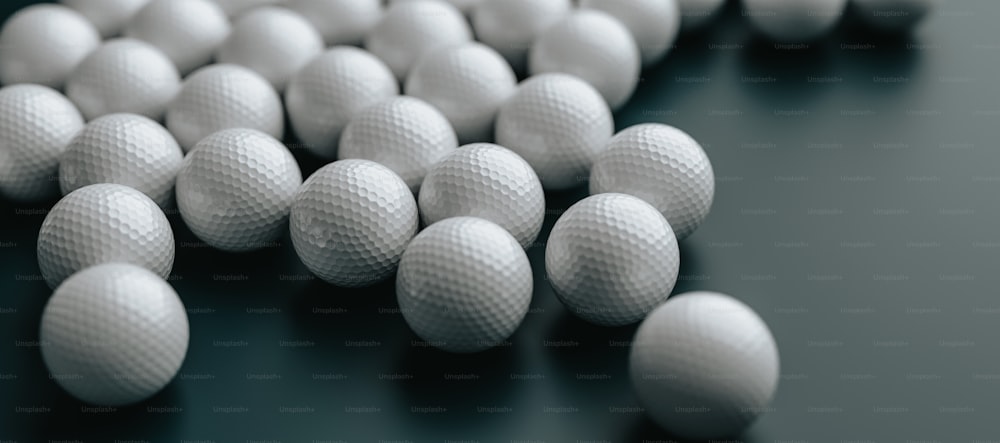 a group of white golf balls on a black surface