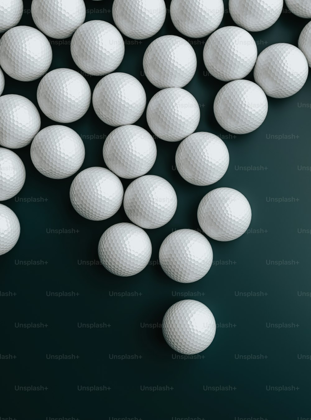 a bunch of white golf balls on a black background