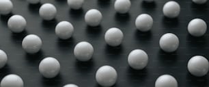 a group of white balls sitting on top of a black surface