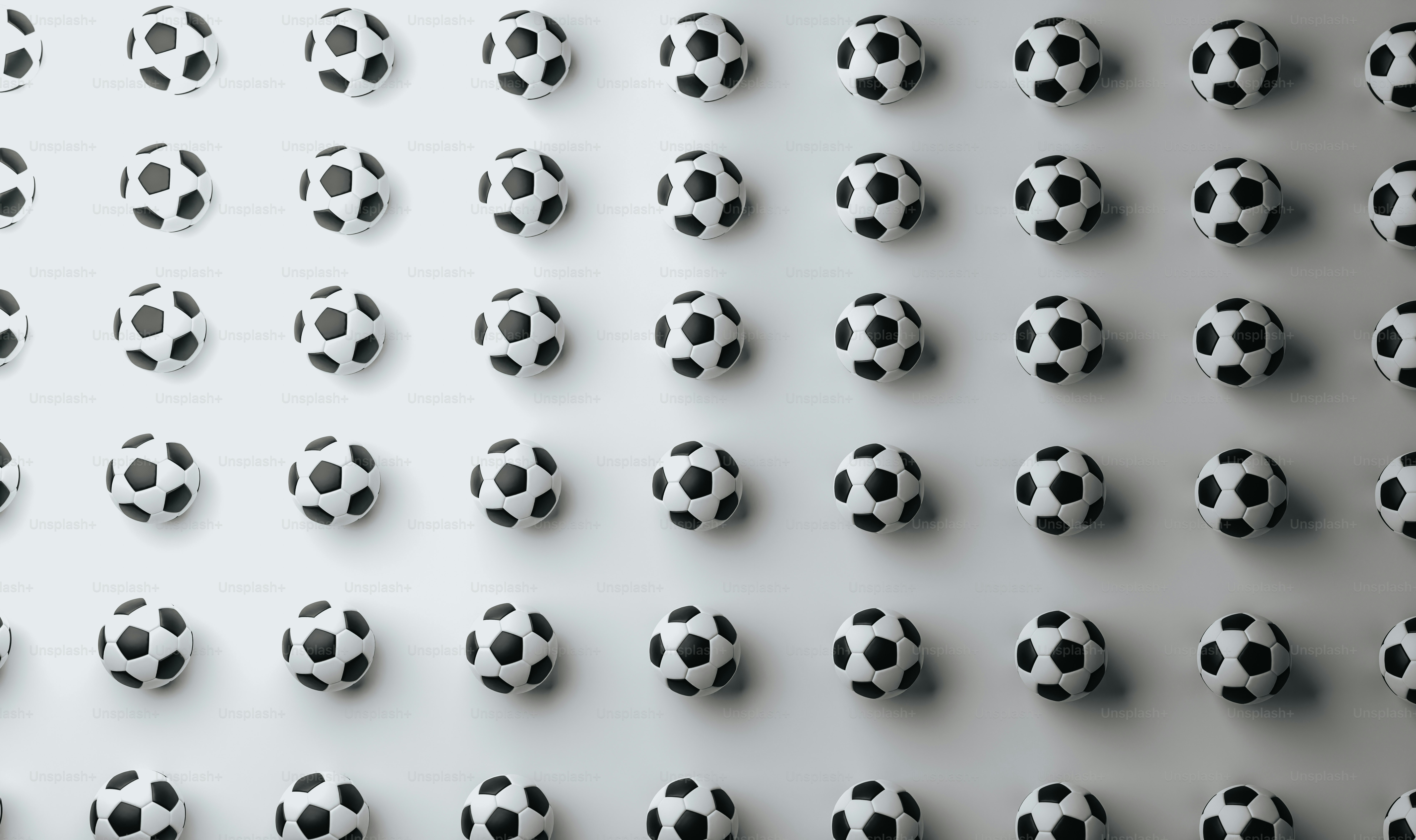 a group of black and white soccer balls