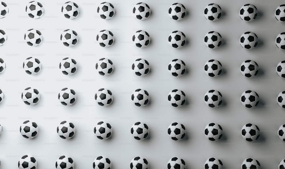 a group of black and white soccer balls