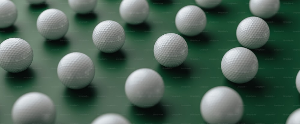 a group of white balls sitting on top of a green surface