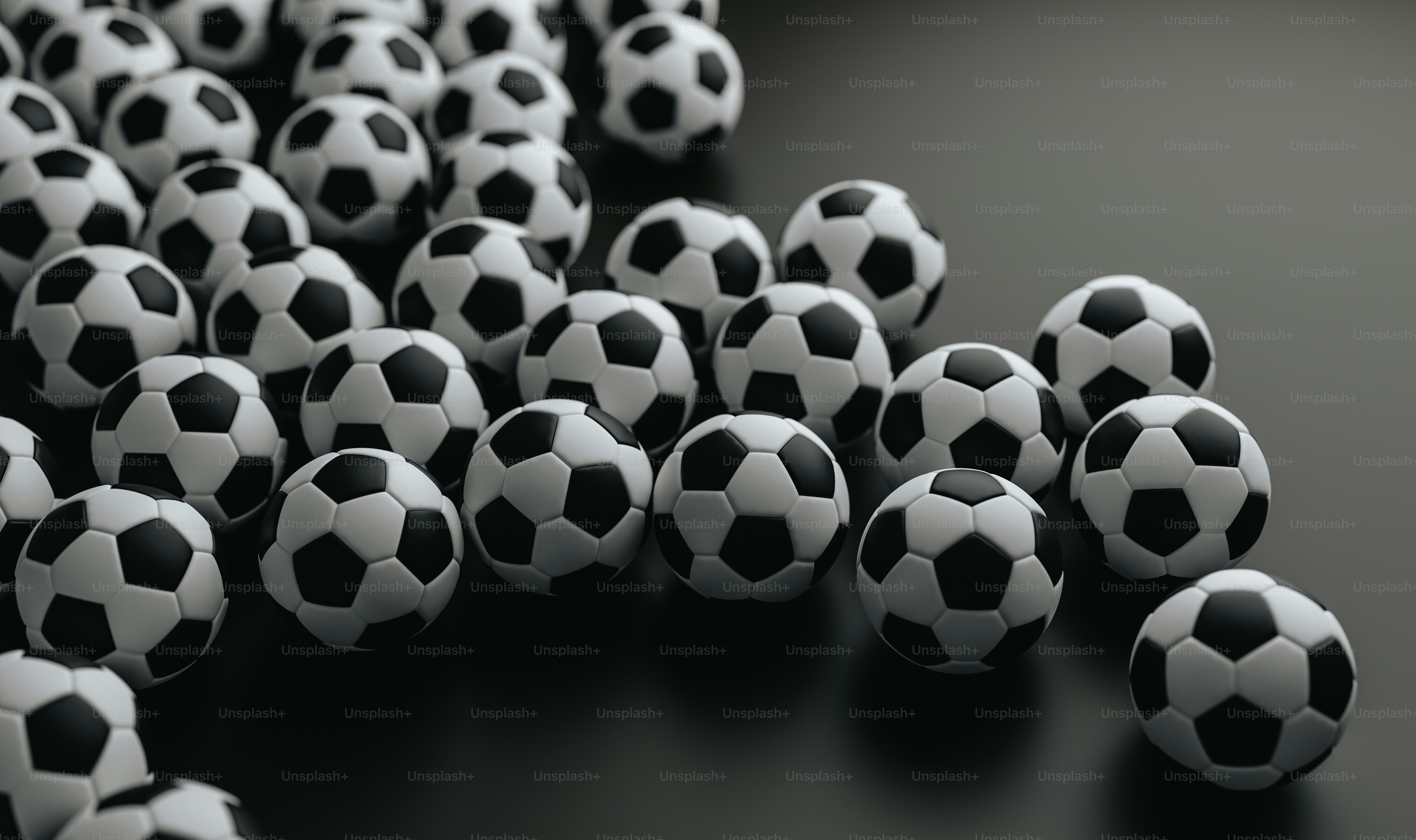 a group of black and white soccer balls