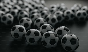 a group of black and white soccer balls