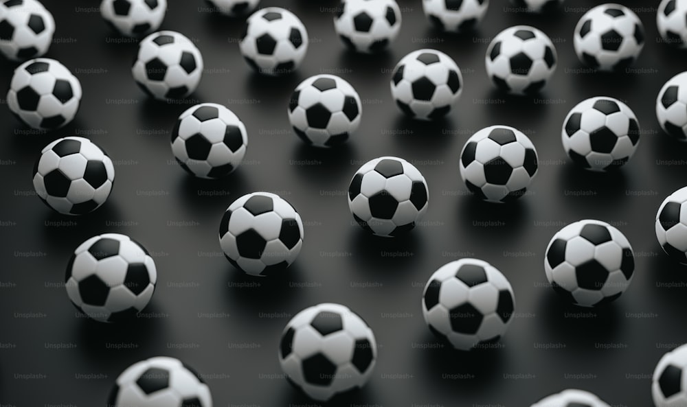 a group of black and white soccer balls