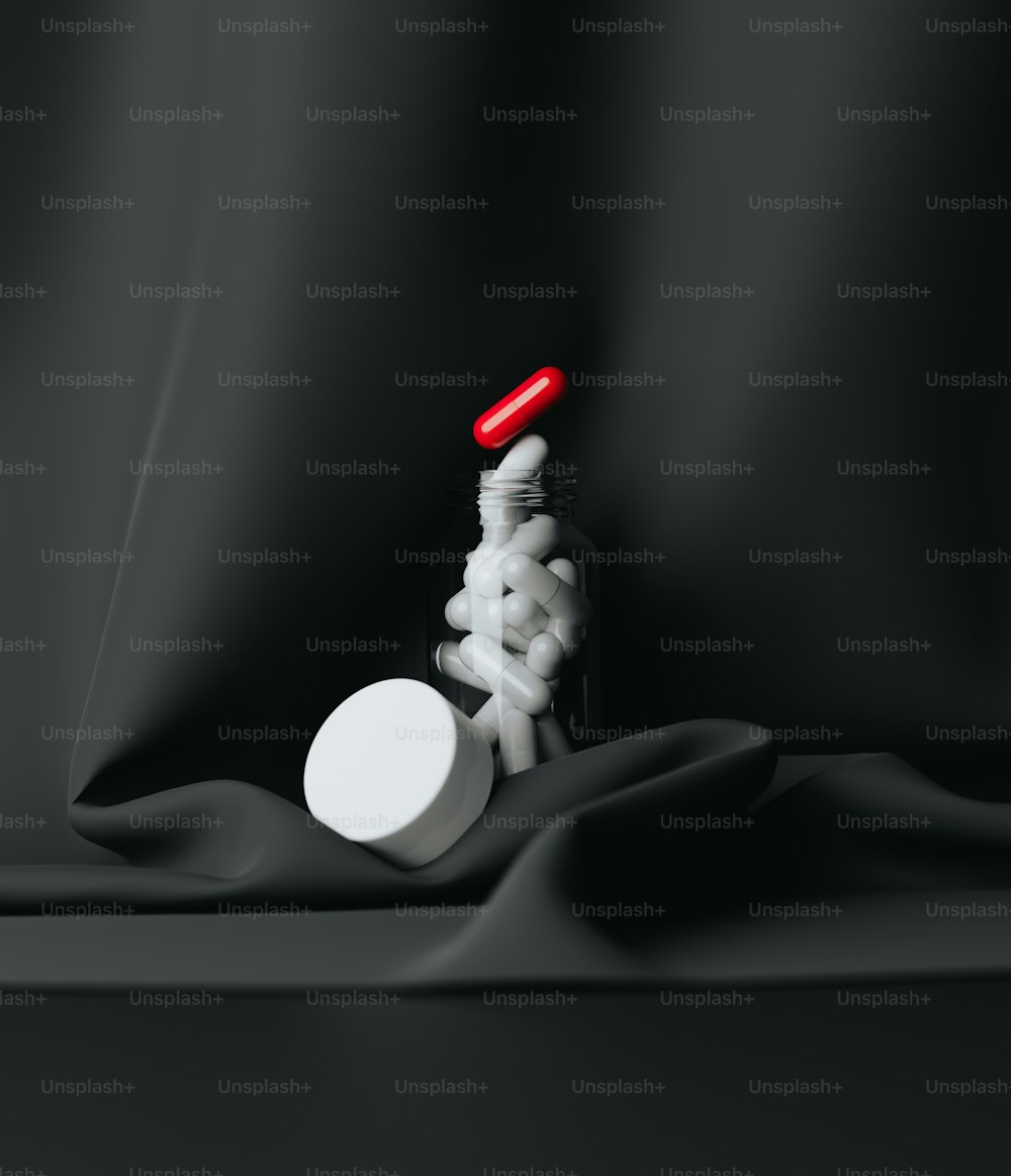 a bottle of pills sitting on top of a black cloth