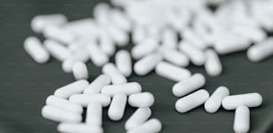 a pile of white pills sitting on top of a table