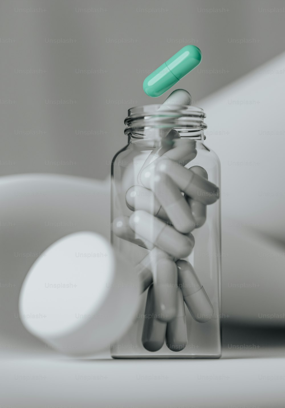 a glass jar filled with pills sitting on top of a table