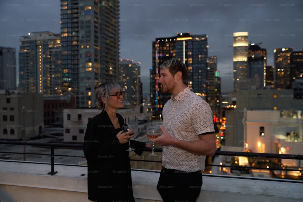 a man and a woman standing on a roof looking at each other